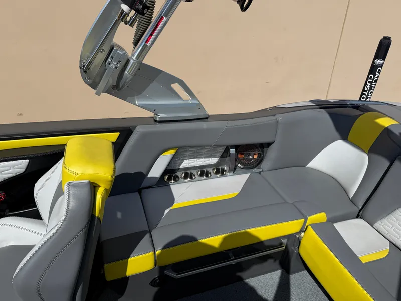 Slide: The Image of 2019 MasterCraft X22 interior with gray and yellow seating, featuring control panel and sleek design. - 18