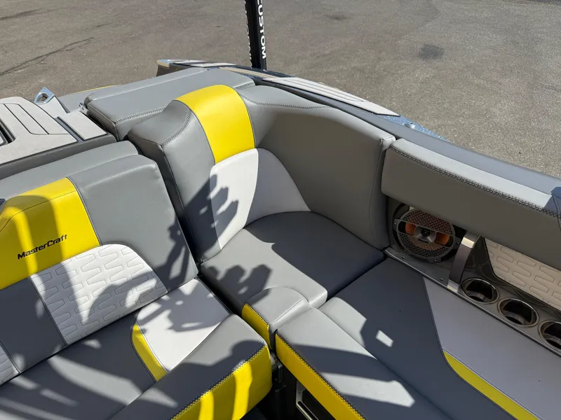 Slide: The Image of 2019 MasterCraft X22 boat interior with gray and yellow seating. - 20