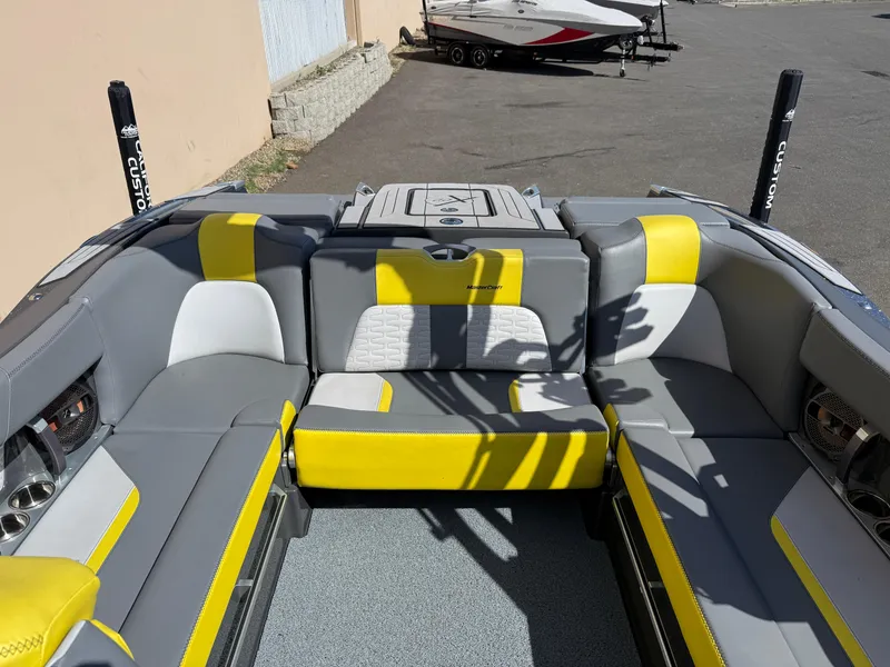 Slide: The Image of 2019 MasterCraft X22 boat interior with gray and yellow seating. - 21
