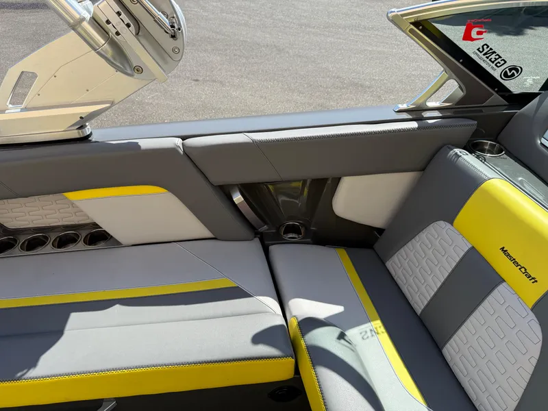 Slide: The Image of 2019 MasterCraft X22 boat interior with gray and yellow seating. - 23