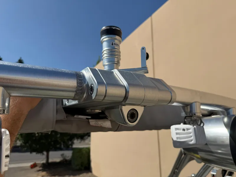 Slide: The Image of Close-up of a 2019 MasterCraft X22 boat's metal hardware and fittings under clear sky. - 30