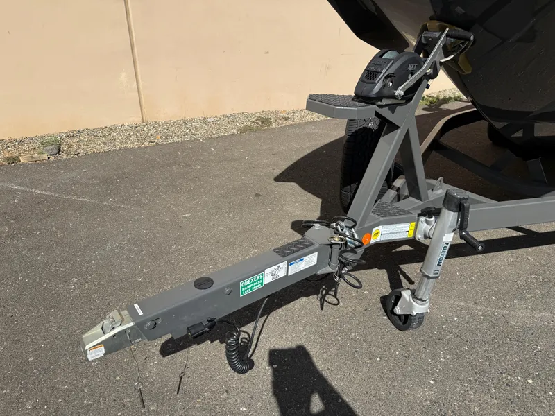 Slide: The Image of Trailer hitch of a 2019 MasterCraft X22 boat on pavement. - 8