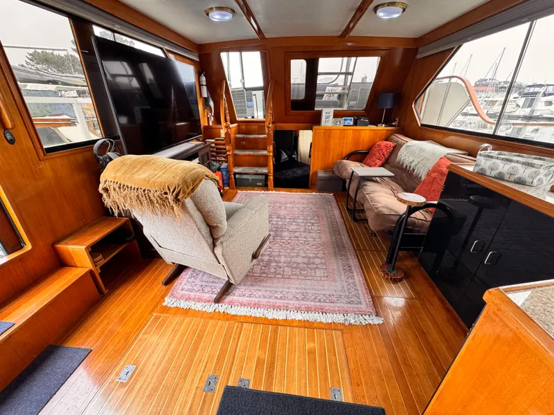 Slide: The Image of Luxurious 1988 Overseas PT52 Cockpit Motoryacht interior with cozy seating and elegant wood finishes. - 1