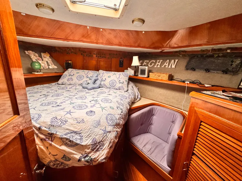 Slide: The Image of Cozy cabin interior of 1988 Overseas PT52 Cockpit Motoryacht with bed and seating area. - 10