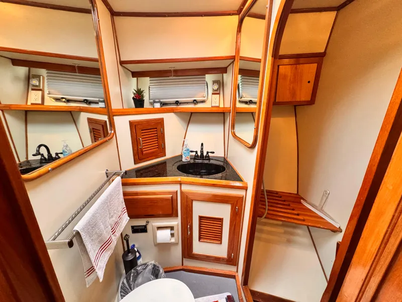 Slide: The Image of Luxurious 1988 Overseas PT52 yacht bathroom with wood accents and modern amenities. - 12