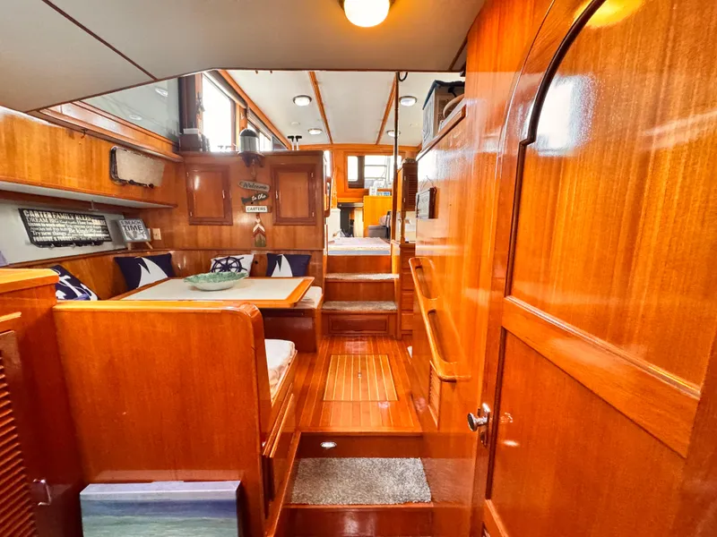 Slide: The Image of Interior of 1988 Overseas PT52 Cockpit Motoryacht with polished wood and cozy seating area. - 13