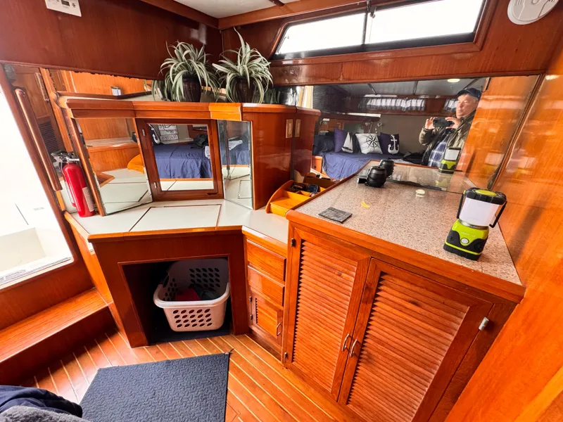 Slide: The Image of Interior of 1988 Overseas PT52 Cockpit Motoryacht with wood cabinetry and mirrored surfaces. - 15