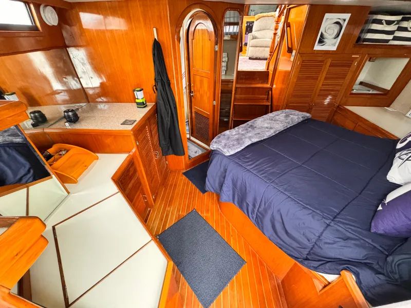 Slide: The Image of Luxurious 1988 Overseas PT52 Cockpit Motoryacht interior with wood finish and cozy bedroom. - 16