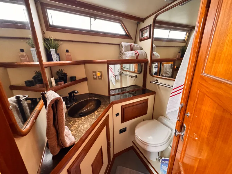 Slide: The Image of Luxurious bathroom in 1988 Overseas PT52 Cockpit Motoryacht with elegant wood accents and modern amenities. - 17