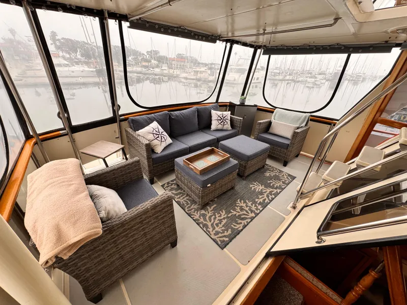 Slide: The Image of Luxurious 1988 Overseas PT52 cockpit motoryacht interior with comfortable seating and marina view. - 18