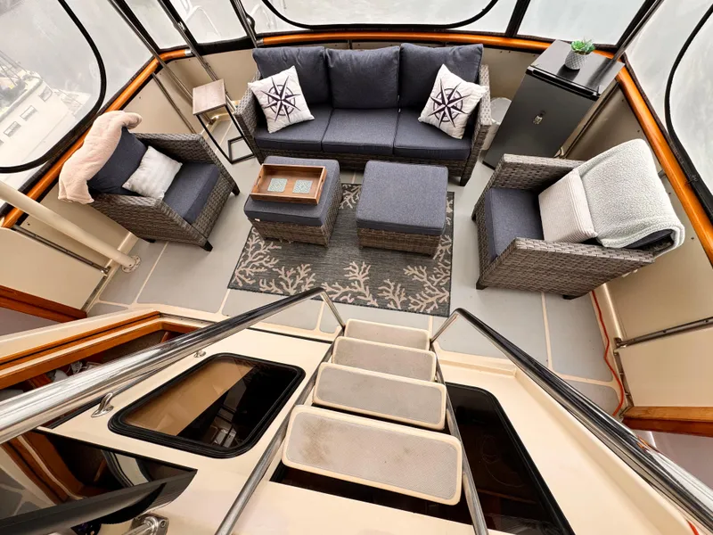 Slide: The Image of Luxurious 1988 Overseas PT52 cockpit motoryacht interior with elegant seating and decor. - 19