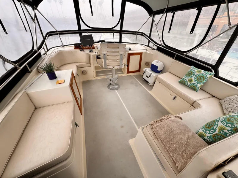 Slide: The Image of 1988 Overseas PT52 Cockpit Motoryacht interior with seating, helm, and decor accents. - 20