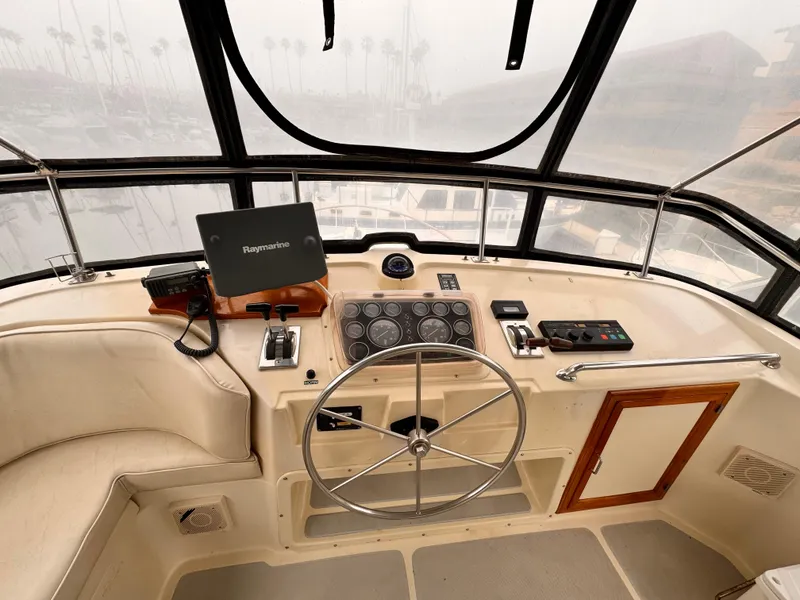 Slide: The Image of Cockpit of 1988 Overseas PT52 Motoryacht with steering wheel and navigation equipment. - 22
