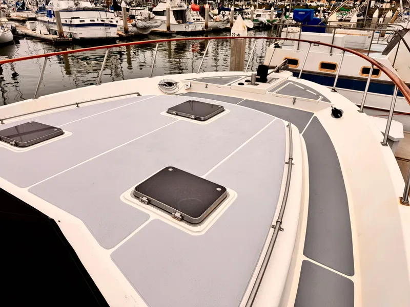 Slide: The Image of 1988 Overseas PT52 Cockpit Motoryacht deck view in marina setting. - 24
