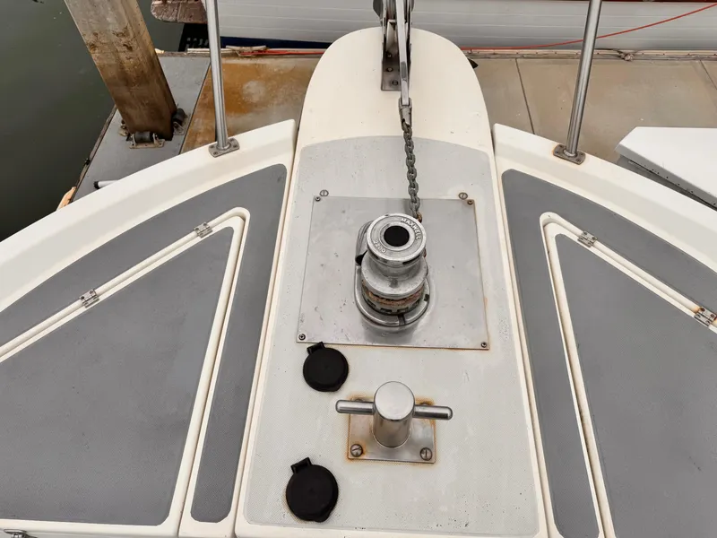 Slide: The Image of 1988 Overseas PT52 Cockpit Motoryacht deck with anchor winch and cleat. - 25