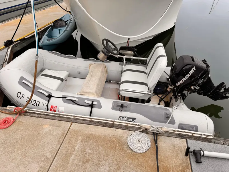 Slide: The Image of Inflatable boat with Mercury motor docked beside Overseas PT52 Cockpit Motoryacht, 1988 model. - 28
