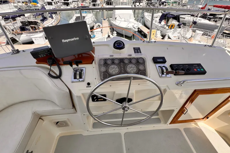 Slide: The Image of Cockpit of 1988 Overseas PT52 Motoryacht with steering wheel and navigation equipment. - 31