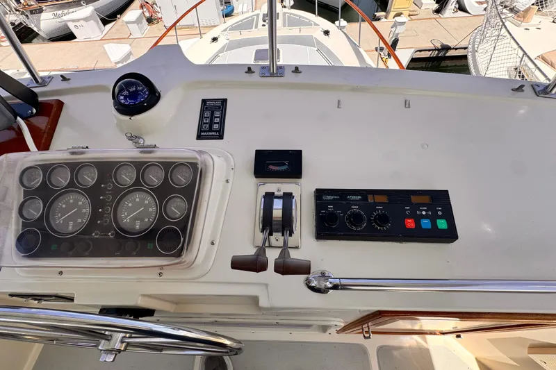 Slide: The Image of 1988 Overseas PT52 Cockpit Motoryacht dashboard with controls and gauges. - 32