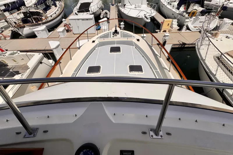 Slide: The Image of 1988 Overseas PT52 Cockpit Motoryacht docked among other boats in a marina. - 34