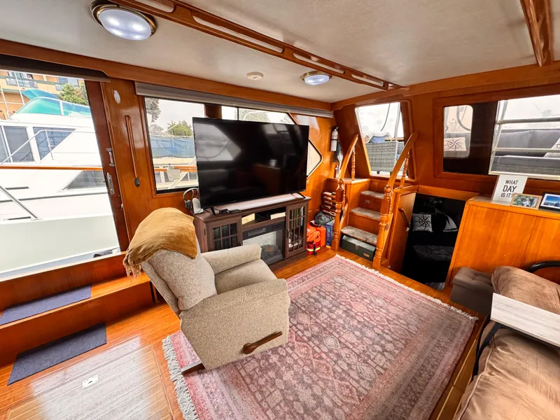 Slide: The Image of Luxurious 1988 Overseas PT52 Cockpit Motoryacht interior with cozy seating and large TV. - 4