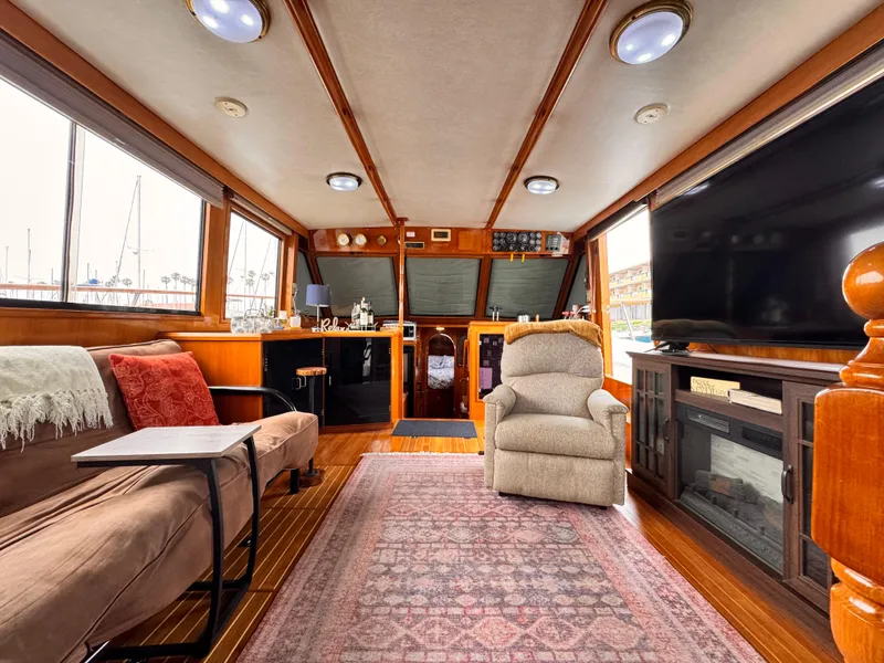 Slide: The Image of Luxurious 1988 Overseas PT52 Cockpit Motoryacht interior with cozy seating and elegant decor. - 5