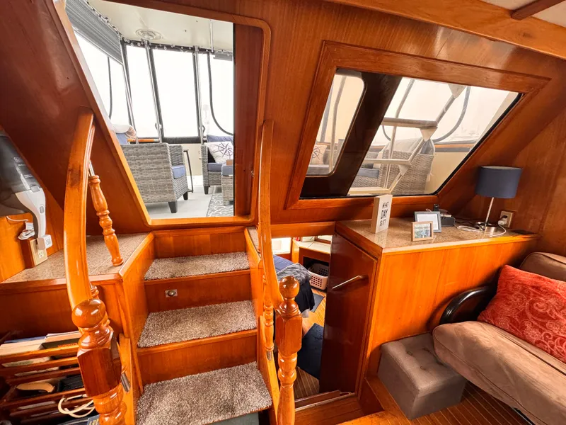 Slide: The Image of Interior of 1988 Overseas PT52 Cockpit Motoryacht with wooden stairs and cozy seating area. - 6