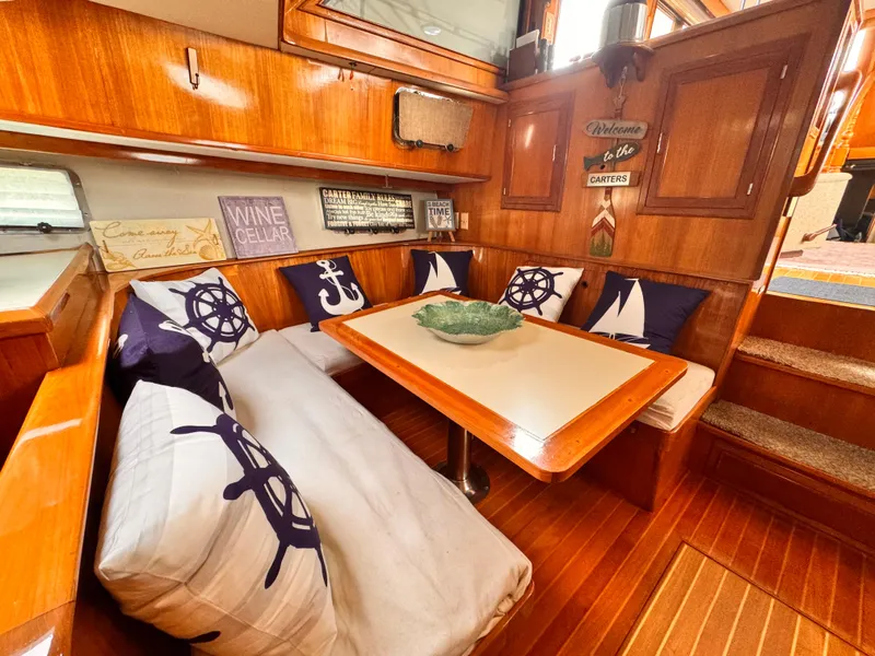 Slide: The Image of 1988 Overseas PT52 Cockpit Motoryacht interior with nautical-themed decor and wooden furnishings. - 9