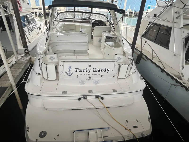 The Image of 2004 Regal Commodore 4260 yacht docked, featuring spacious seating and "Party Hardy" signage. - 0
