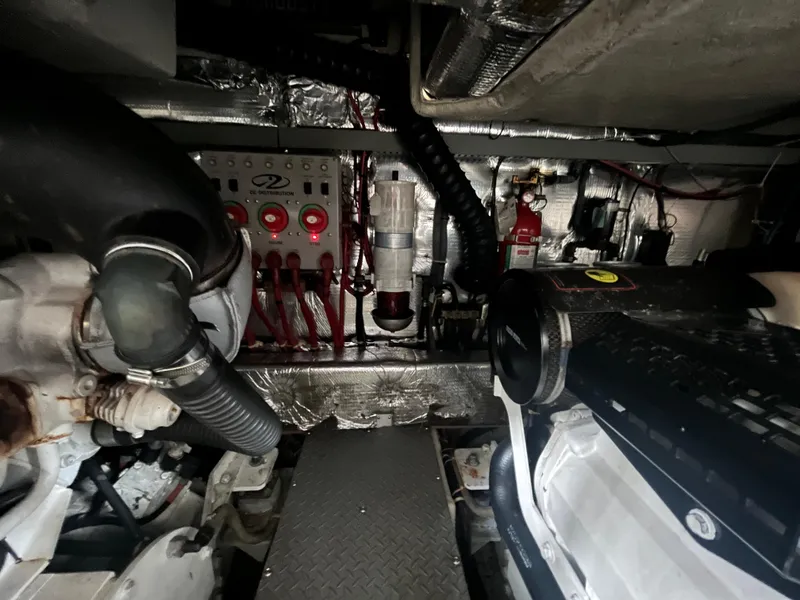 Slide: The Image of Engine room of a 2004 Regal Commodore 4260 yacht, showcasing mechanical components and wiring. - 12