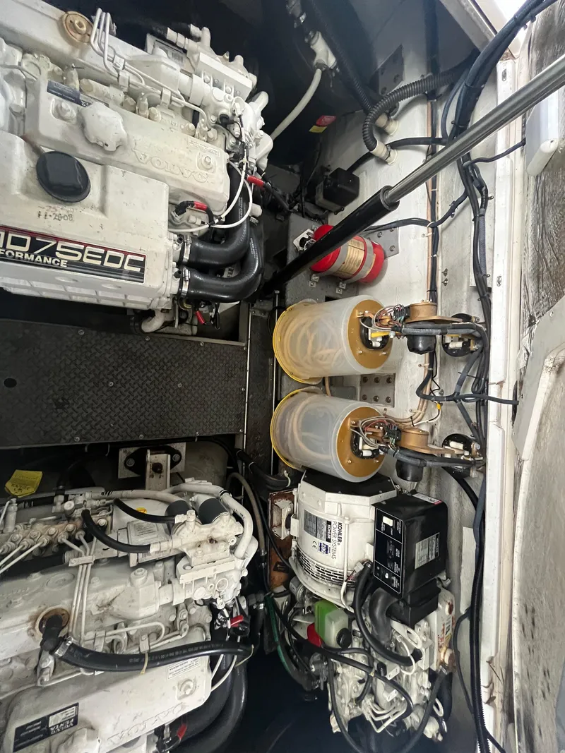 Slide: The Image of Engine compartment of a 2004 Regal Commodore 4260 boat, showcasing mechanical components and systems. - 13