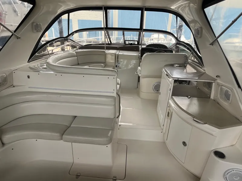 Slide: The Image of 2004 Regal Commodore 4260 yacht interior with white seating and kitchenette. - 16