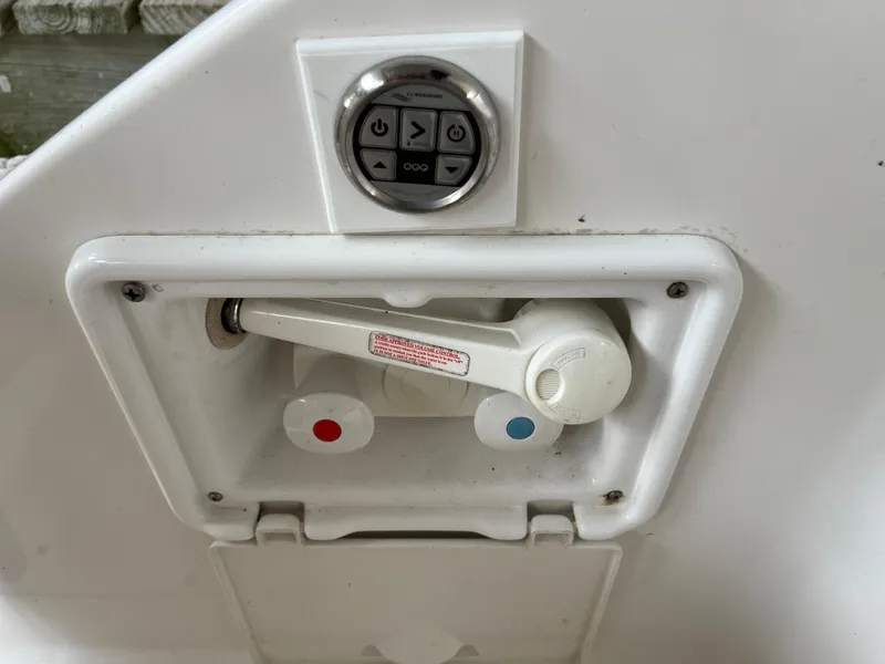 Slide: The Image of 2004 Regal Commodore 4260 boat control panel with faucet and temperature knobs. - 33