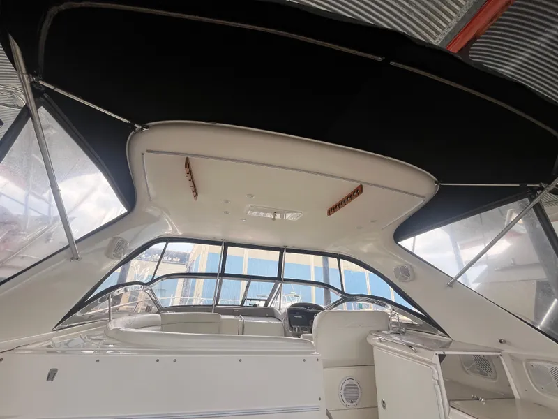 Slide: The Image of 2004 Regal Commodore 4260 boat interior with black canopy and seating area. - 35