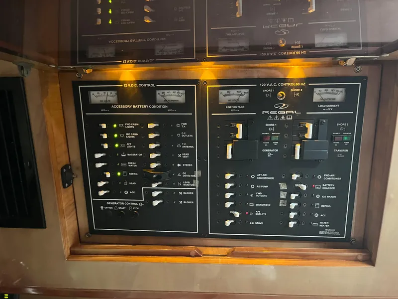 Slide: The Image of Control panel of a 2004 Regal Commodore 4260 boat, featuring various switches and indicators. - 36