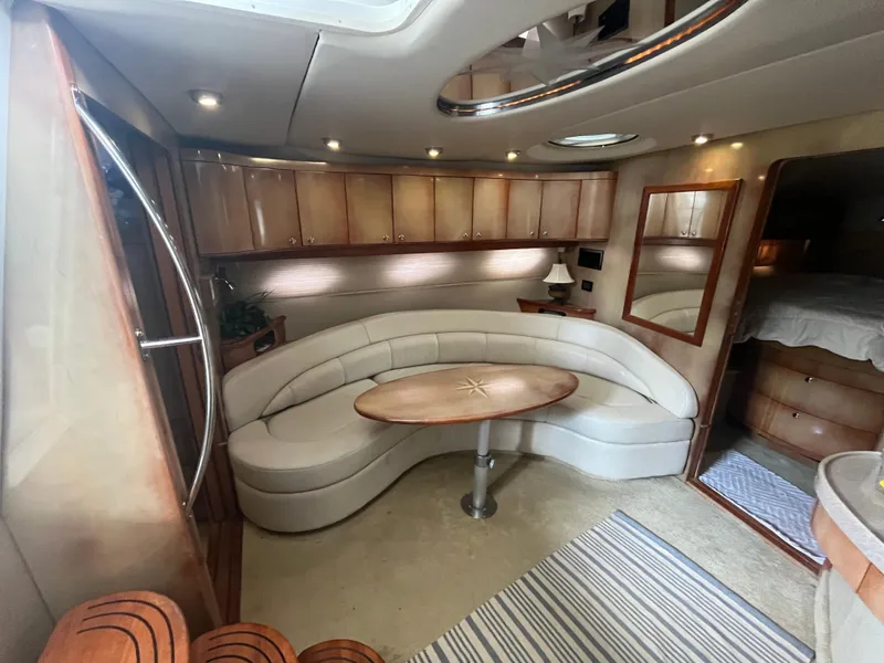 Slide: The Image of Luxurious interior of 2004 Regal Commodore 4260 yacht with elegant seating and wooden cabinetry. - 38