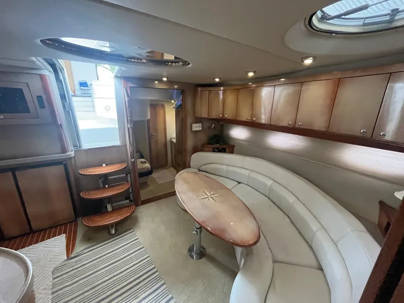 Slide: The Image of Luxurious interior of 2004 Regal Commodore 4260 yacht with elegant seating and wooden accents. - 43