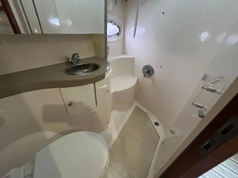 Slide: The Image of 2004 Regal Commodore 4260 yacht bathroom with sink, toilet, and shower. - 44