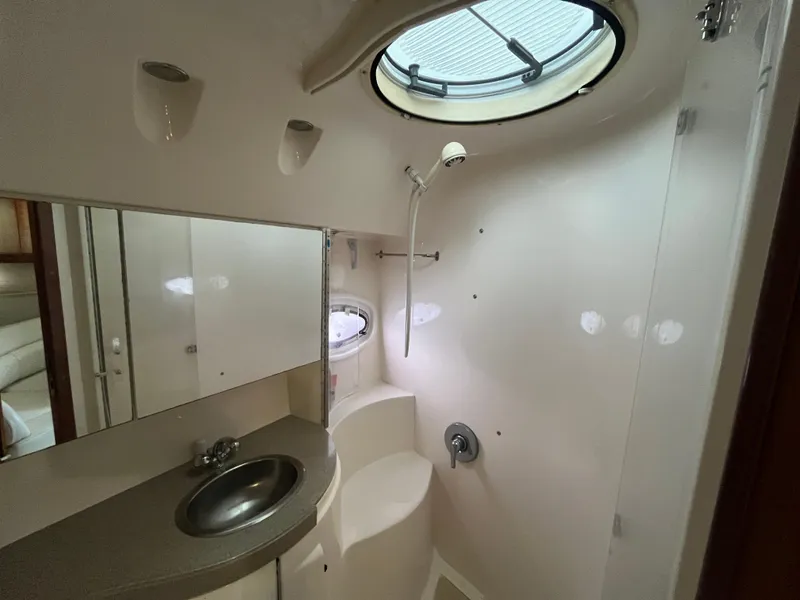 Slide: The Image of 2004 Regal Commodore 4260 yacht bathroom with sink, mirror, and shower. - 45