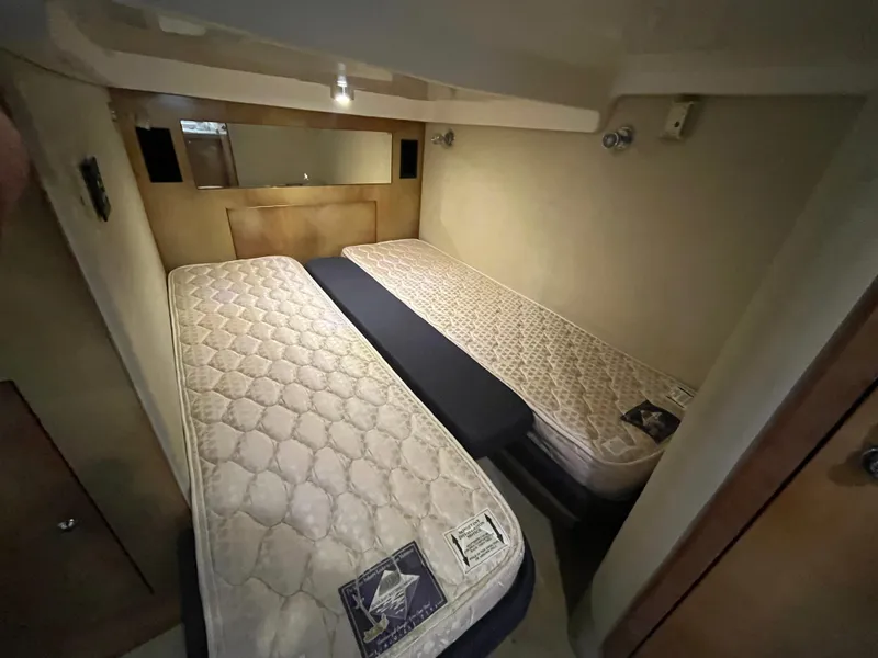 Slide: The Image of 2004 Regal Commodore 4260 cabin with twin beds and beige interior. - 49