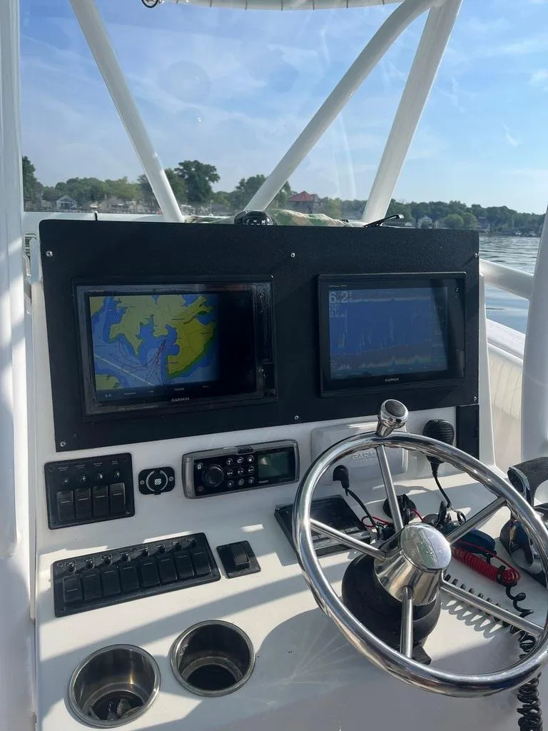 Slide: The Image of 2015 AmeraCat 27 boat dashboard with navigation screens and steering wheel. - 11