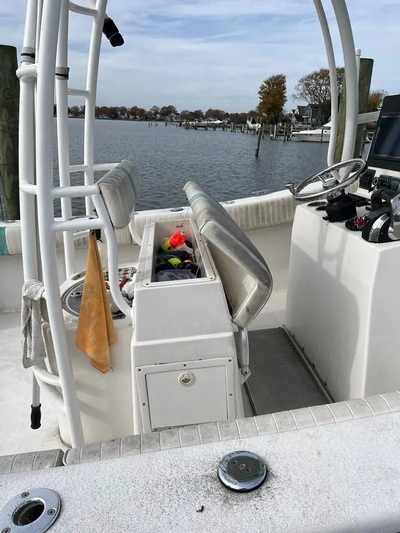 Slide: The Image of 2015 AmeraCat 27 boat interior with open storage, electronics, and water view. - 13