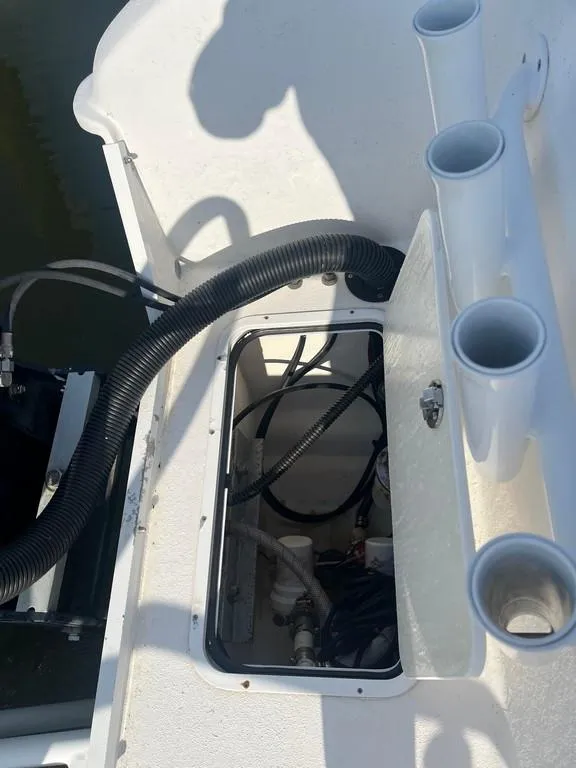 Slide: The Image of 2015 AmeraCat 27 boat deck with open hatch and rod holders. - 17