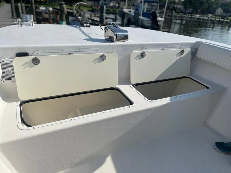 Slide: The Image of 2015 AmeraCat 27 boat storage compartments open on deck. - 20