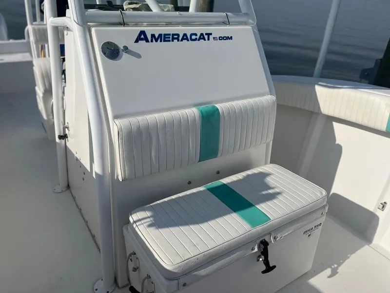 Slide: The Image of 2015 AmeraCat 27 boat interior with white and teal seating. - 22