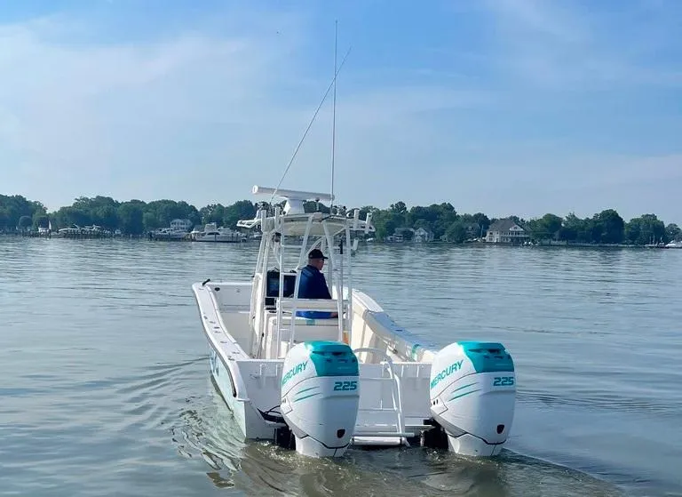 Slide: The Image of 2015 AmeraCat 27 boat with twin Mercury 225 engines on calm water. - 3