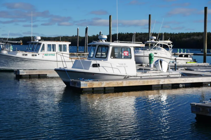 Slide: The Image of 2005 Privateer 2400 boat docked at marina on a sunny day. - 1