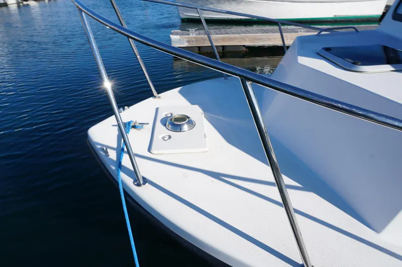 Slide: The Image of Bow of a 2005 Privateer 2400 boat with railing and mooring line. - 13