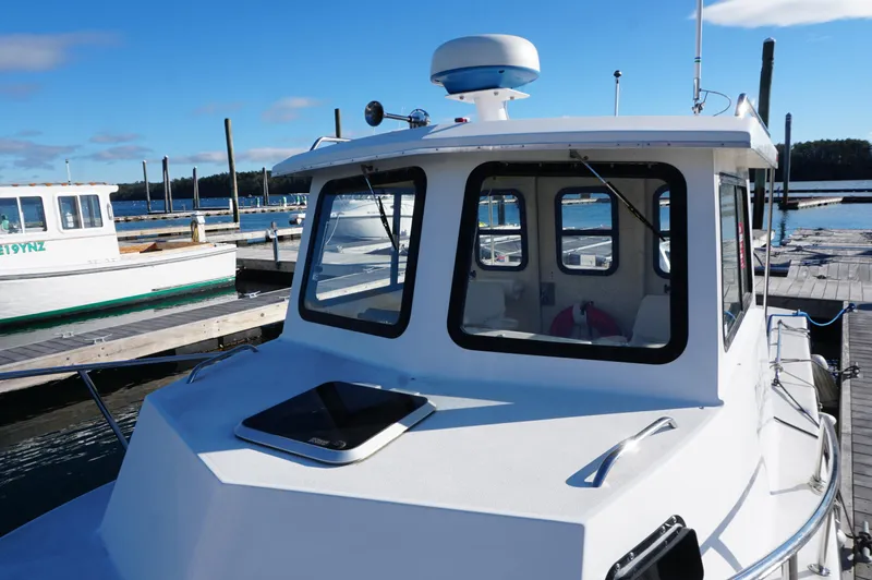 Slide: The Image of Privateer 2400 boat, 2005 model, docked at marina under clear blue sky. - 14