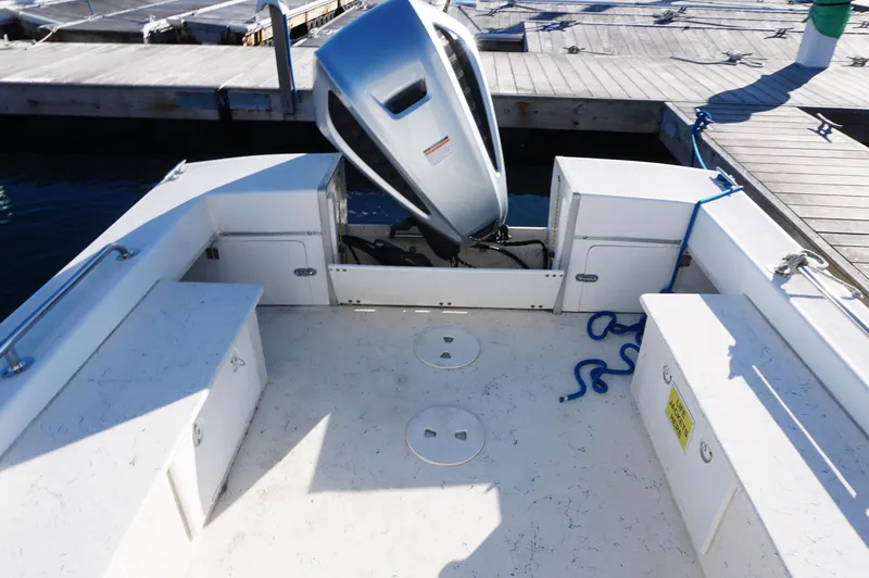 Slide: The Image of Privateer 2400 boat deck with motor, docked, 2005 model. - 6