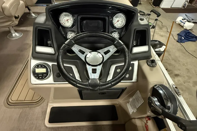 Slide: The Image of Steering console of a 2021 Ranger 223FC boat with gauges and controls. - 11